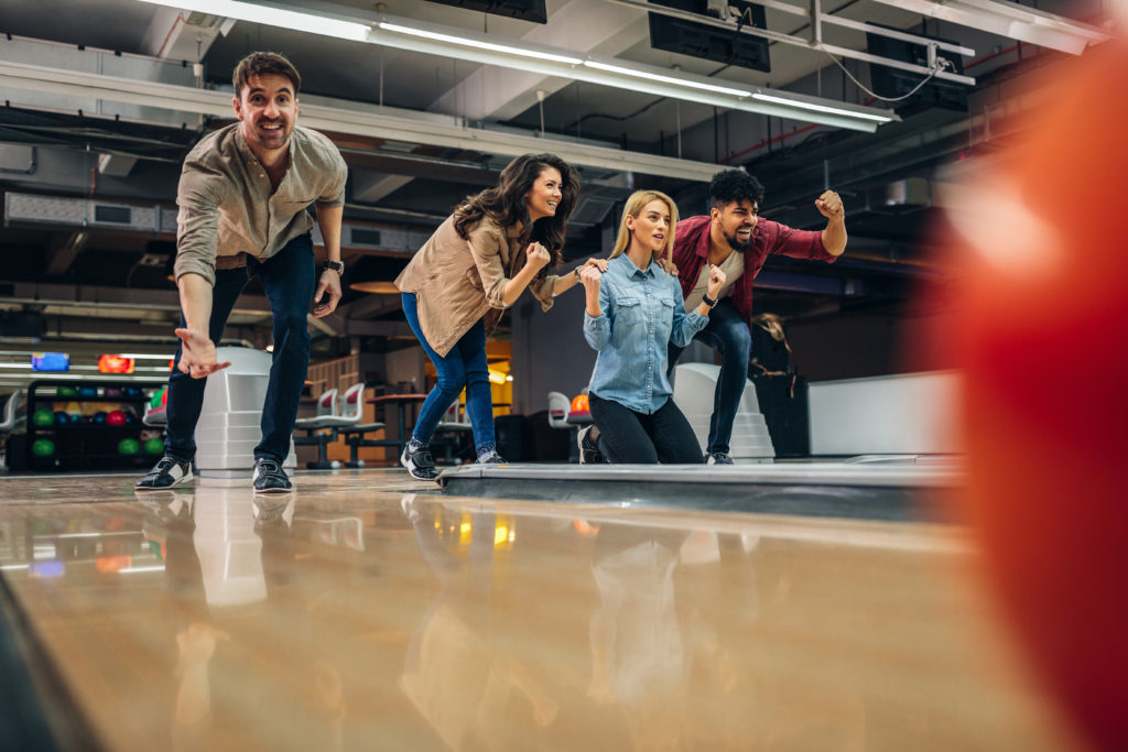 Shot of an attractive young man throwing a bowling ball