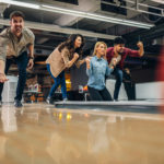 Shot of an attractive young man throwing a bowling ball